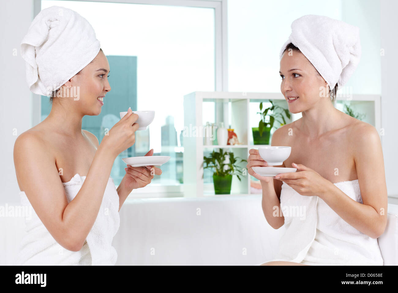 Girls in bath towels communicating in spa salon Stock Photo - Alamy