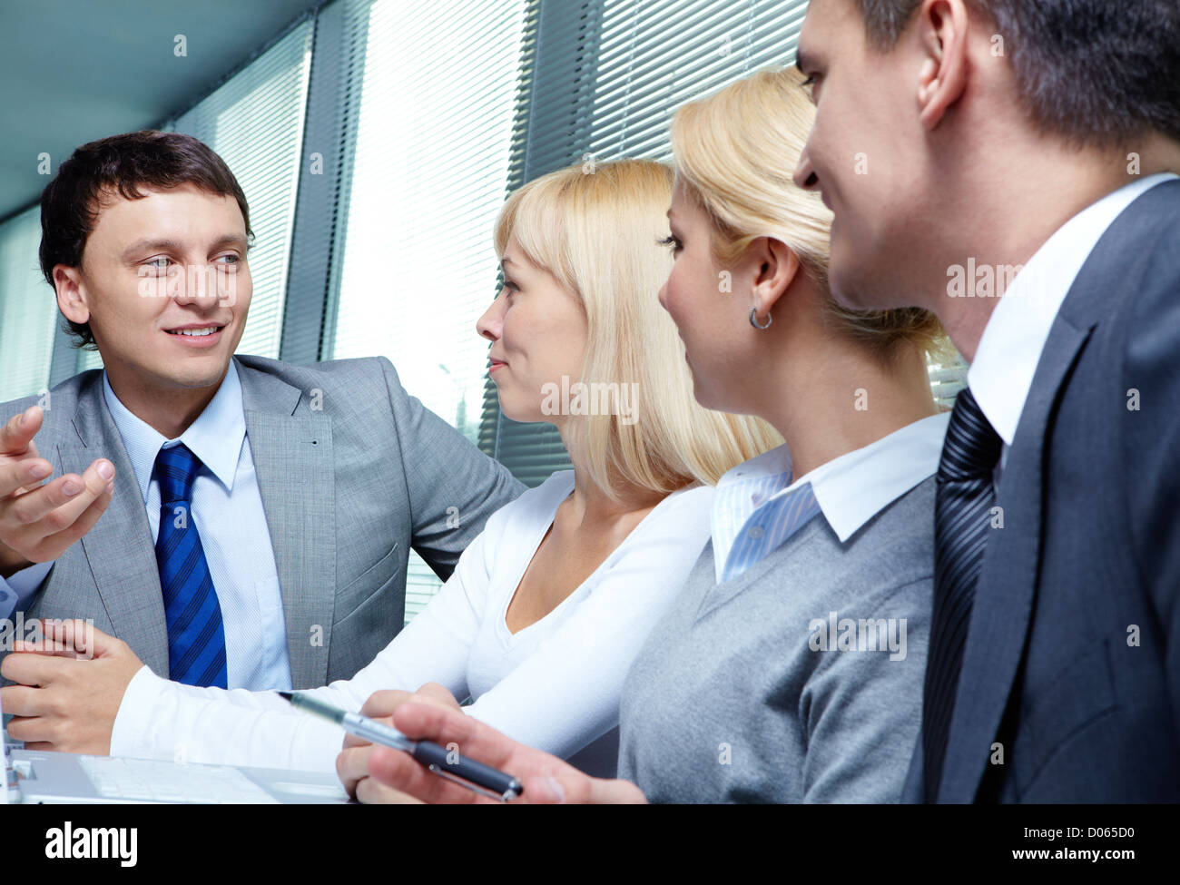 Four business people working at meeting Stock Photo - Alamy