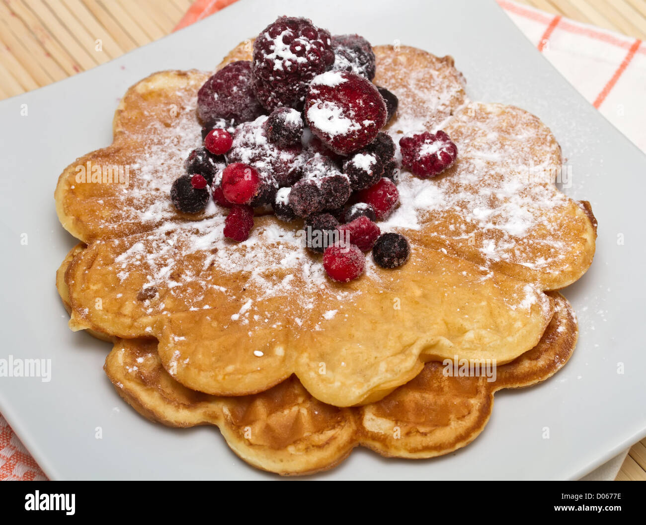 Wafers with berries and powdered sugar Stock Photo