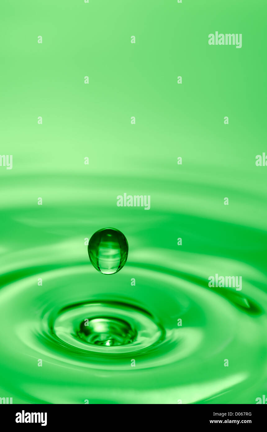 Close-up of a water drop that hits the water surface Stock Photo - Alamy