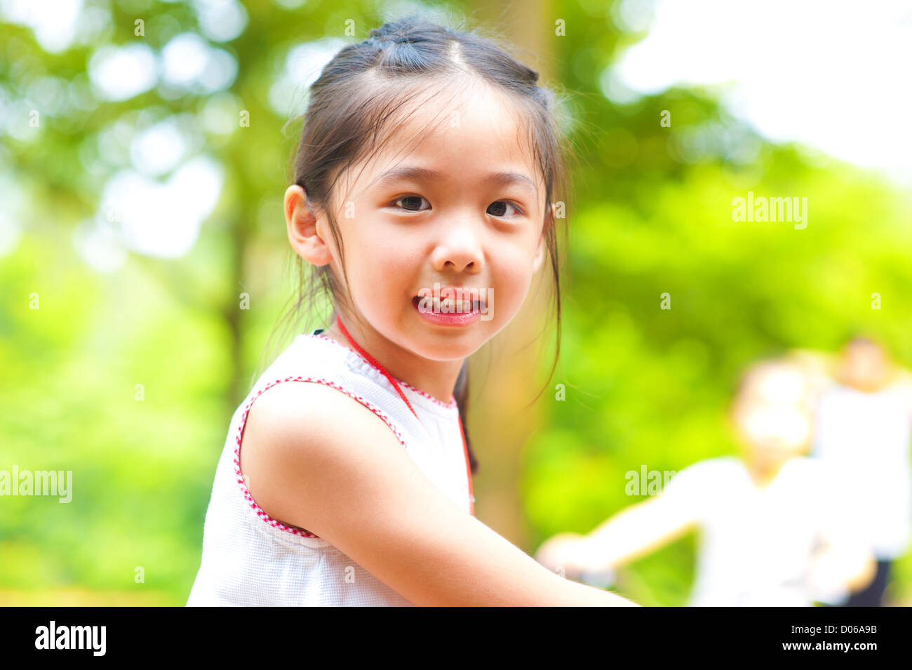 Little Asian girl riding bike outdoor Stock Photo