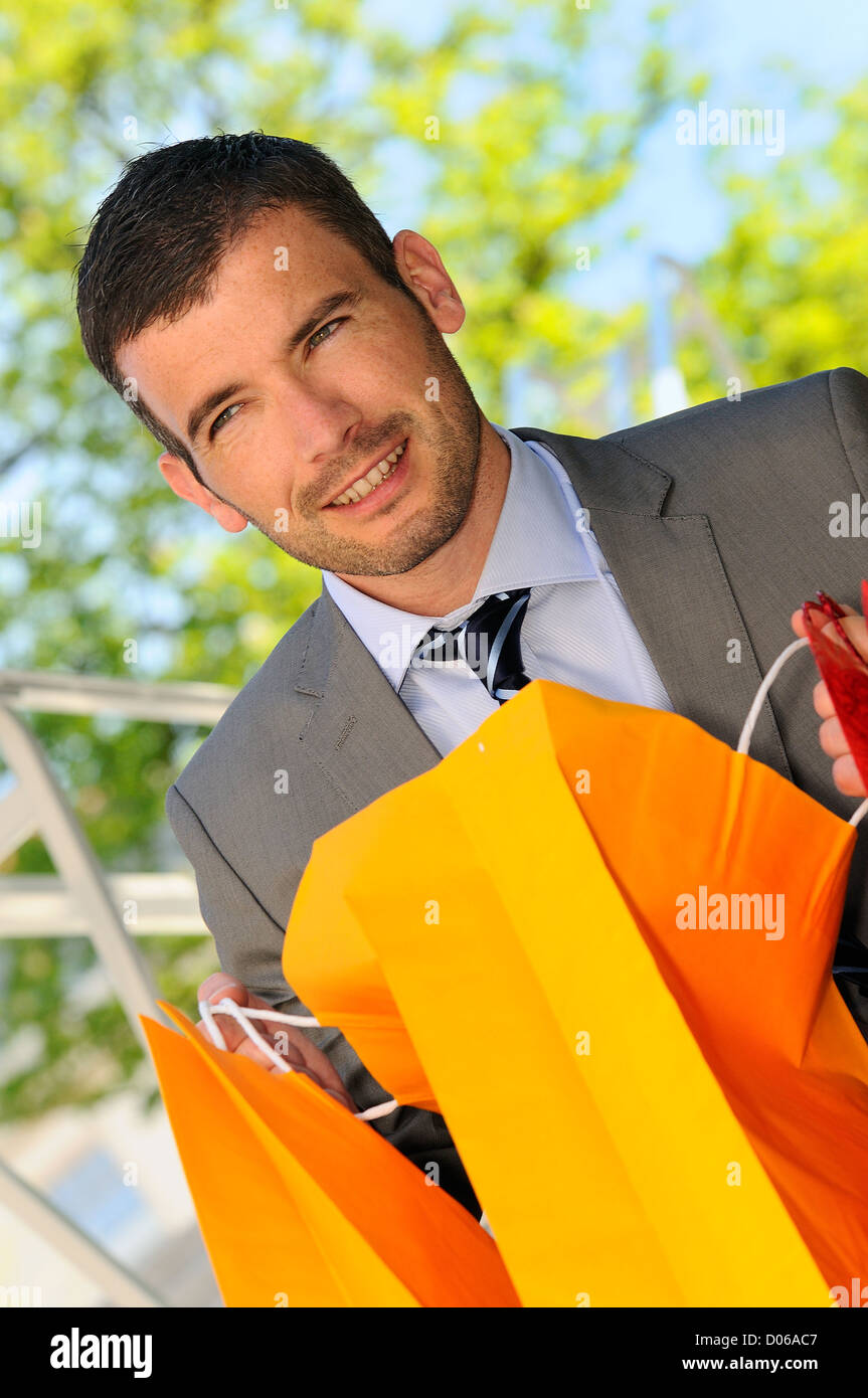 great businessman outdoor with colored shopping bags Stock Photo