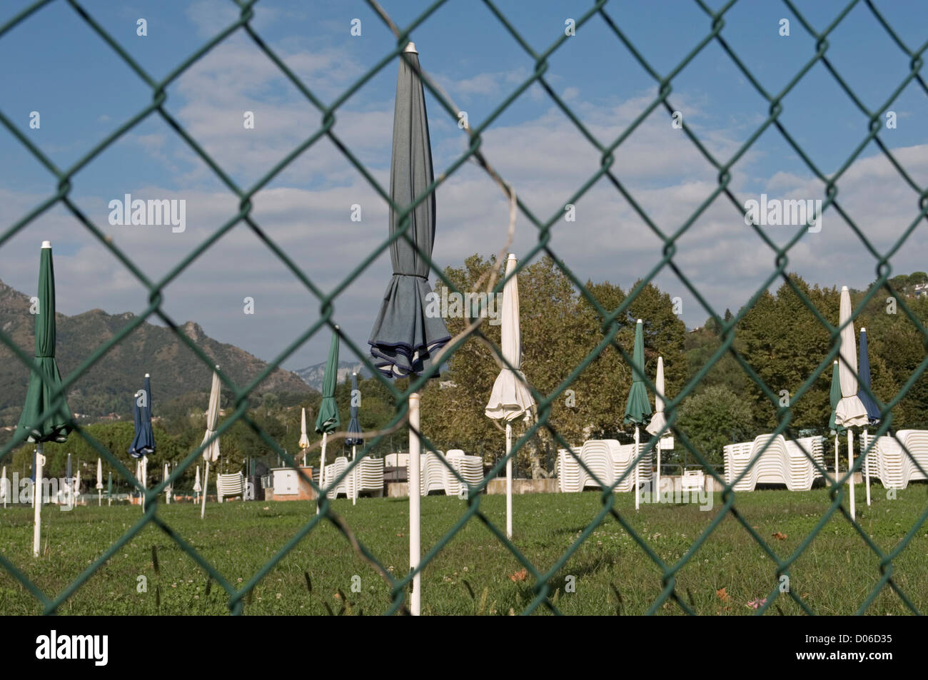 lowered sunshades behind fencing net, Garlate, Lombardy, Italy Stock