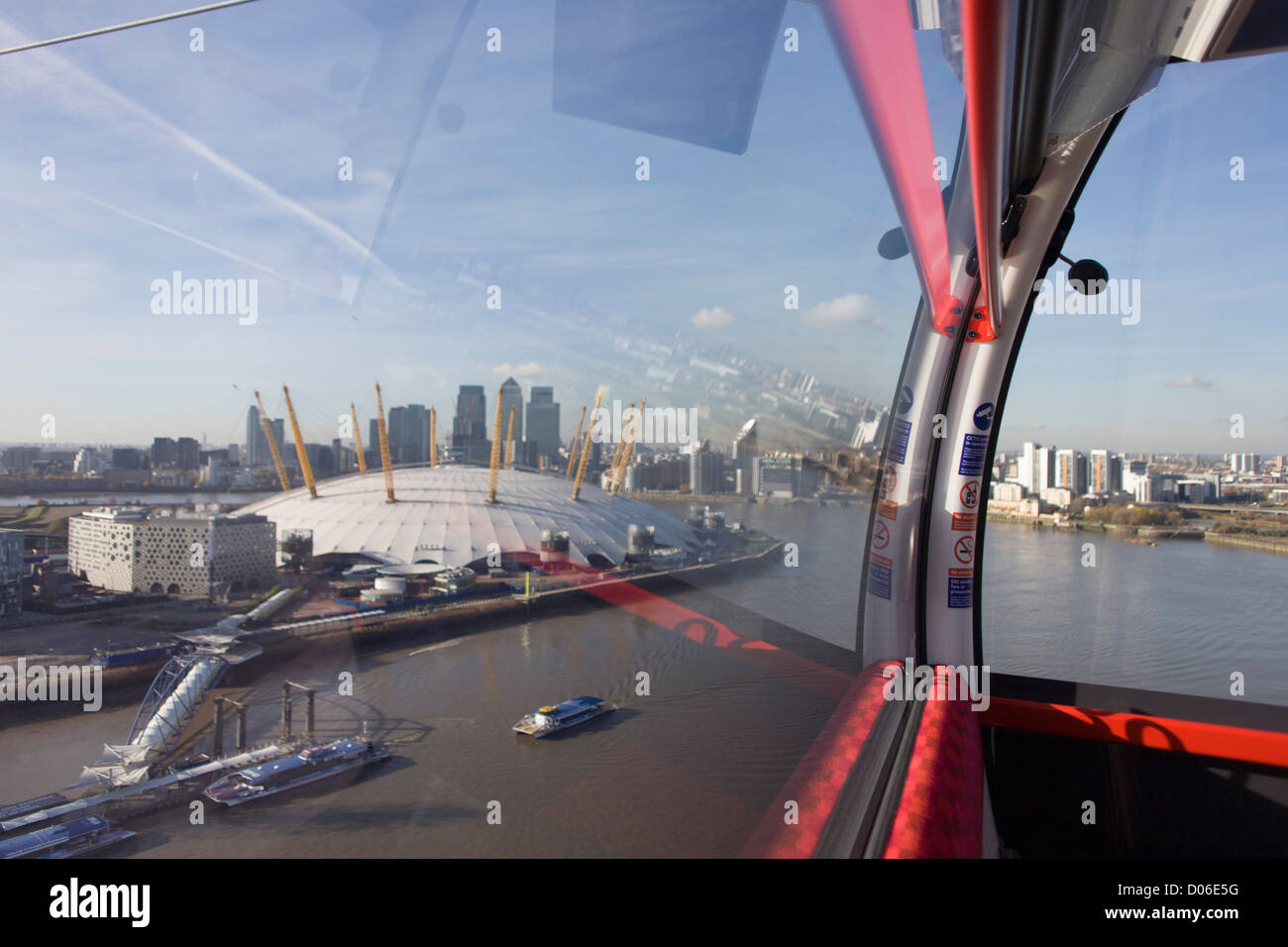 The southbound view from a gondola on a journey over the River Thames on the Emirates Cable Car, from Royal Docks towards the o2 arena on the Greenwich Peninsular. There are 34 gondolas, each with a maximum capacity of 10 passengers. The Emirates Air Line (also known as the Thames cable car) is a cable car link across the River Thames in London built with sponsorship from the airline Emirates. The service opened on 28 June 2012 and is operated by Transport for London. Stock Photo