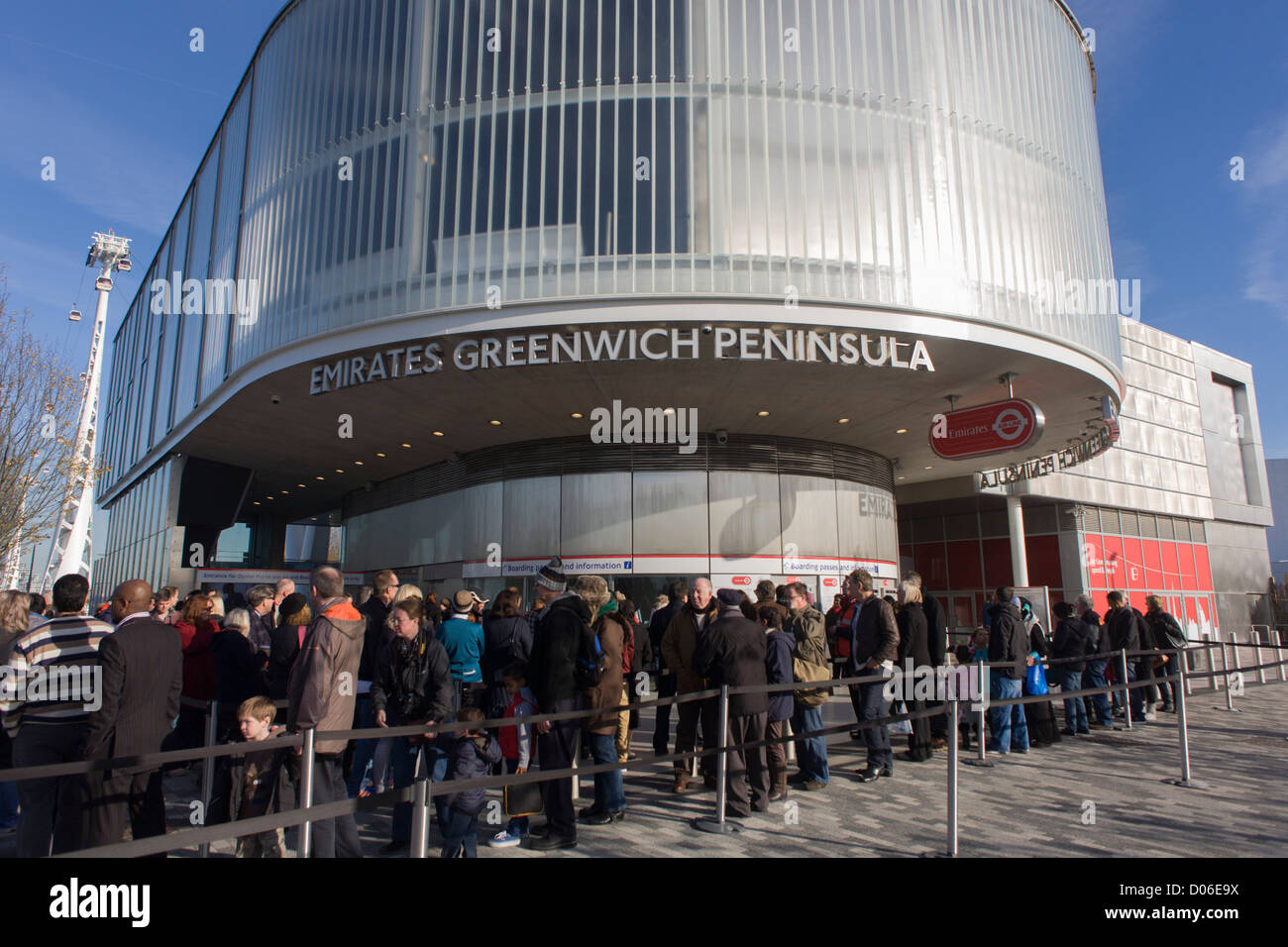 Passengers queue at the southern Greenwich Peninsular terminus of the (Emirates) Thames Cable Car, London. There are 34 gondolas, each with a maximum capacity of 10 passengers. The Emirates Air Line (also known as the Thames cable car) is a cable car link across the River Thames in London built with sponsorship from the airline Emirates. The service opened on 28 June 2012 and is operated by Transport for London. Stock Photo