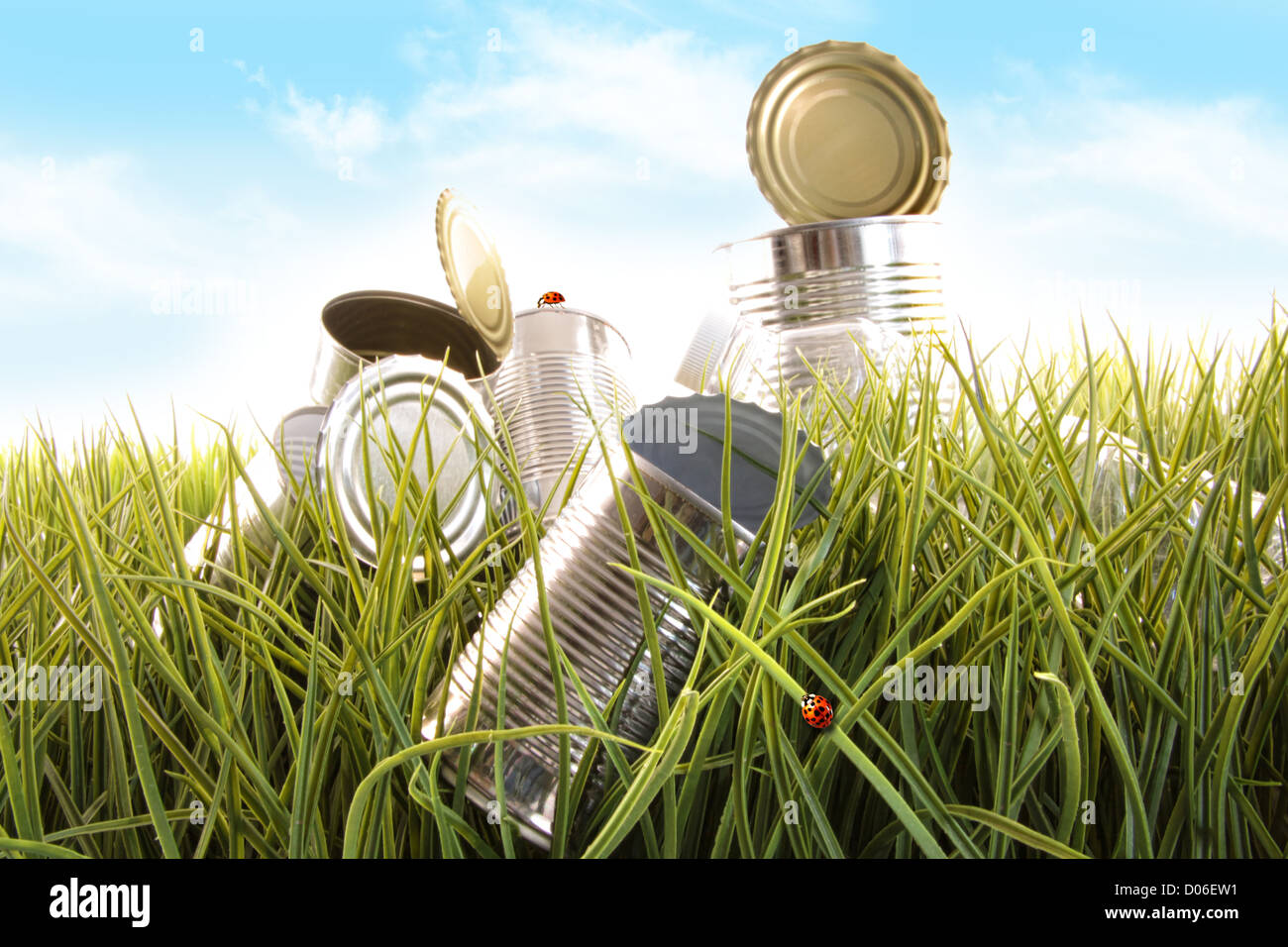 empty cans and bottles laying in the grass Stock Photo Alamy