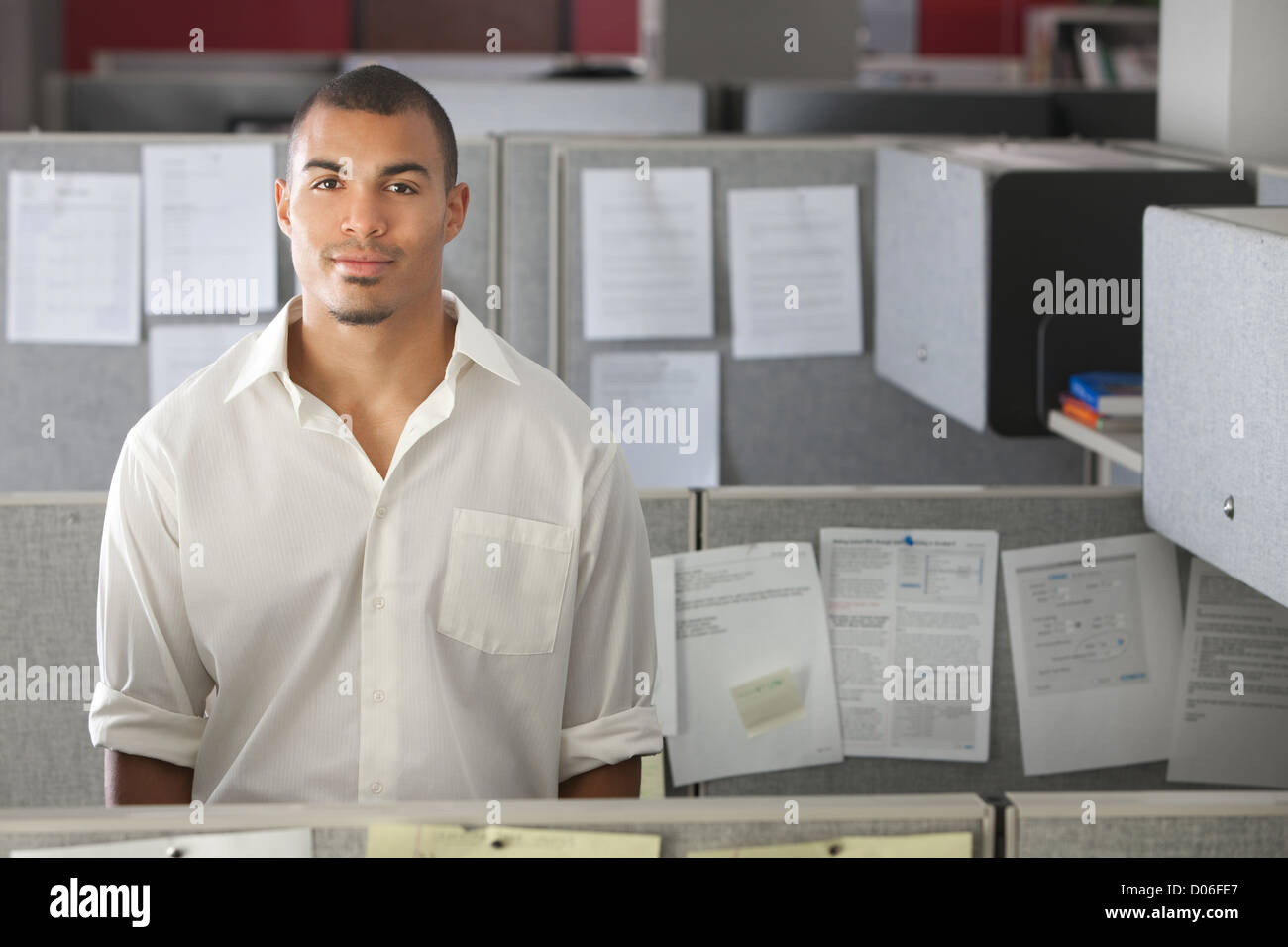 Portrait of handsome man standing in office cubicle Stock Photo - Alamy