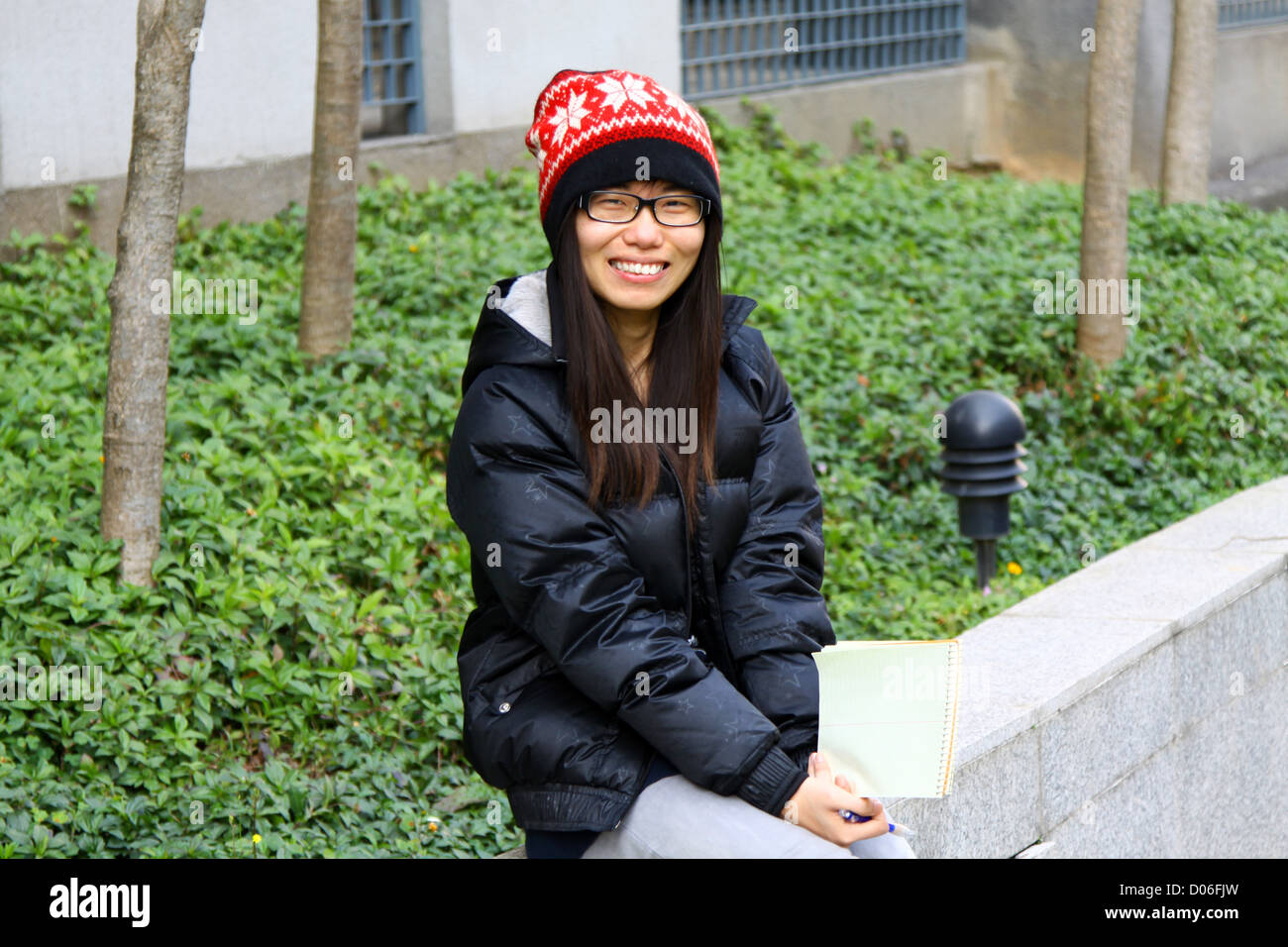Asian student smiling on campus Stock Photo
