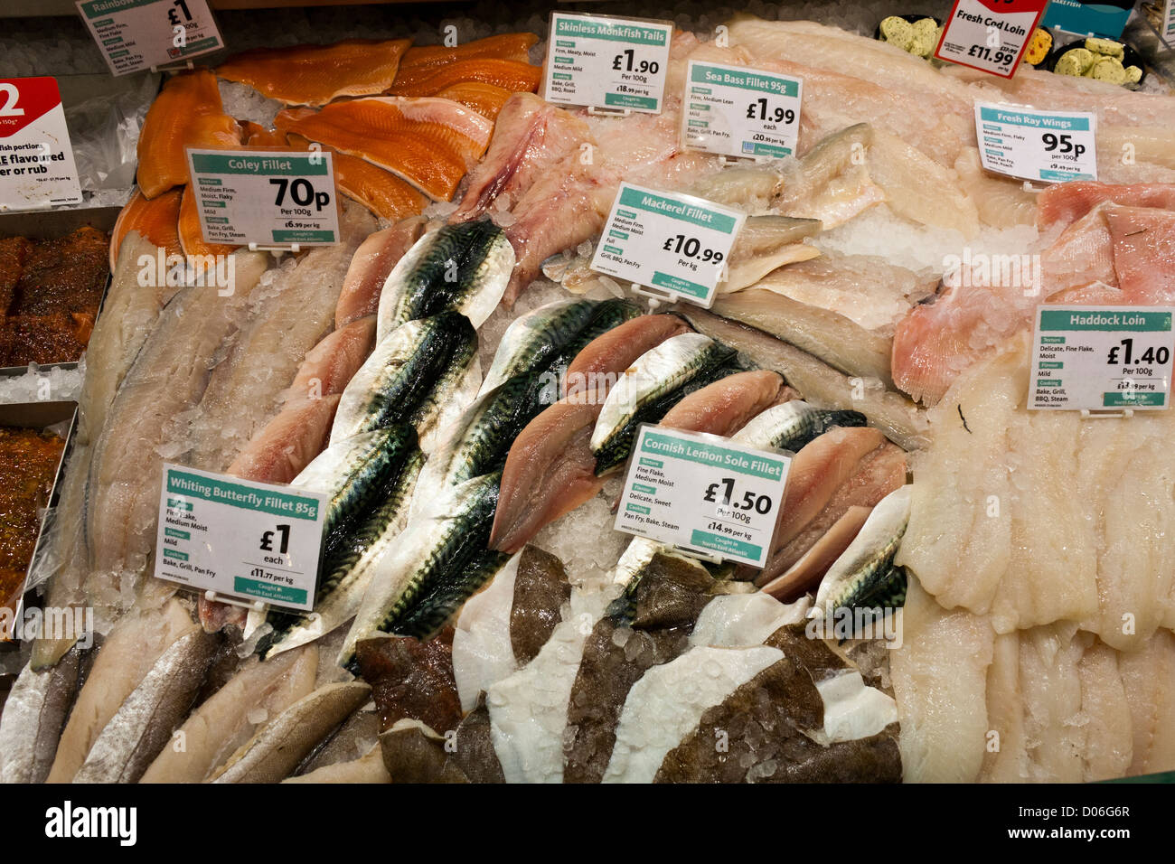 Fresh fish displayed on the fishmongers counter at a Morrison's supermarket Stock Photo