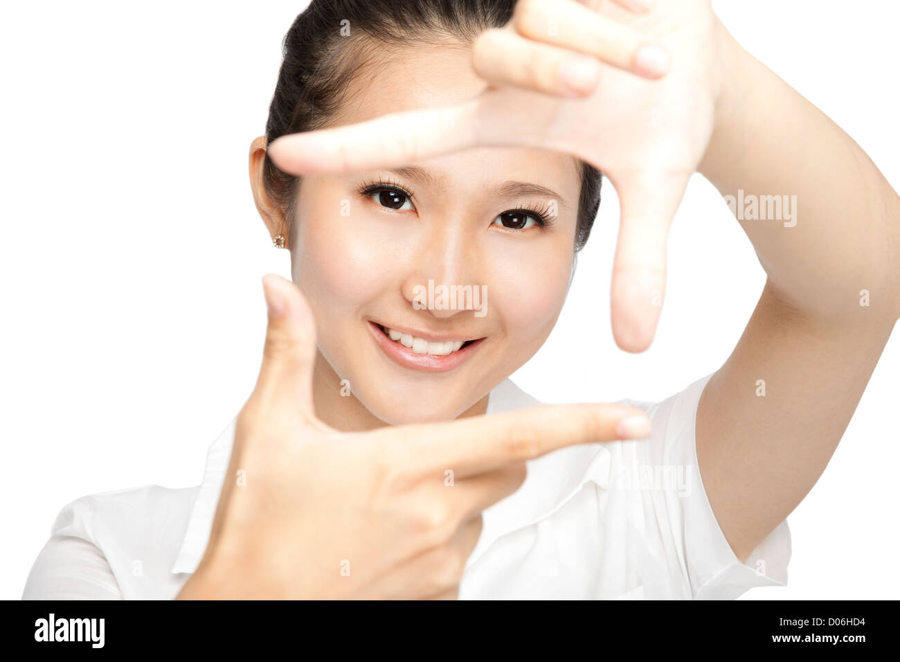 Portrait of smiling young woman making a hand frame isolated on white ...