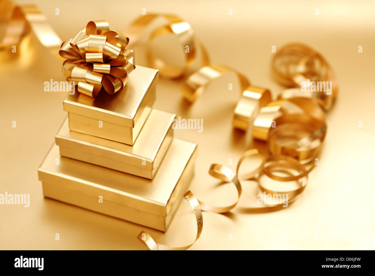 golden christmas gifts on gold background Stock Photo Alamy