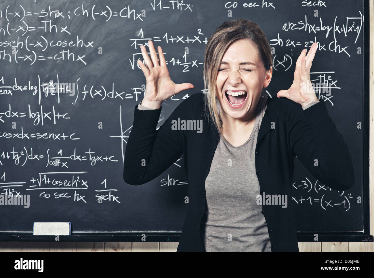 portrait of stressed teacher and blackboard background Stock Photo