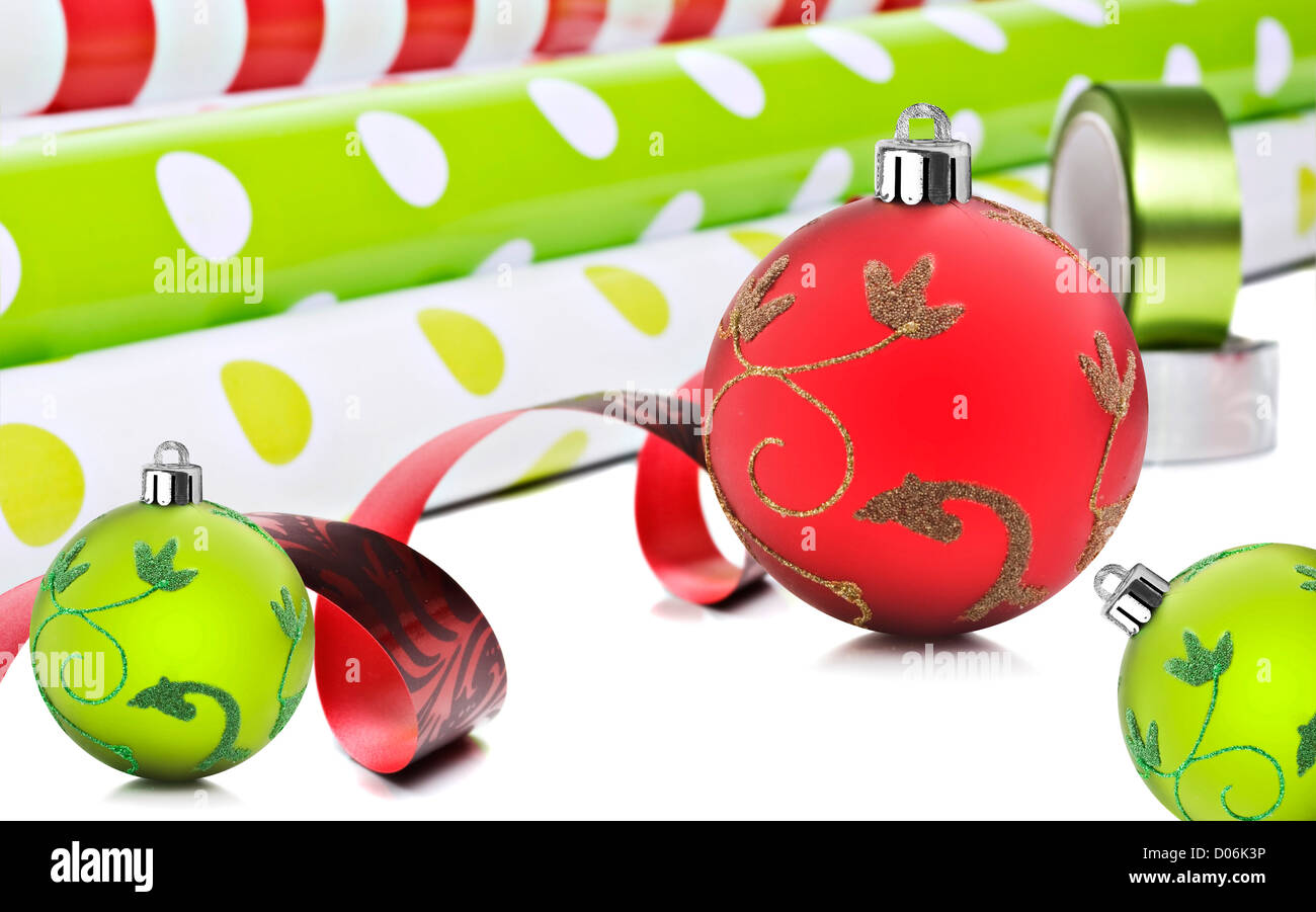 Rolls of gift wrapping paper and ribbon with red and green christmas
