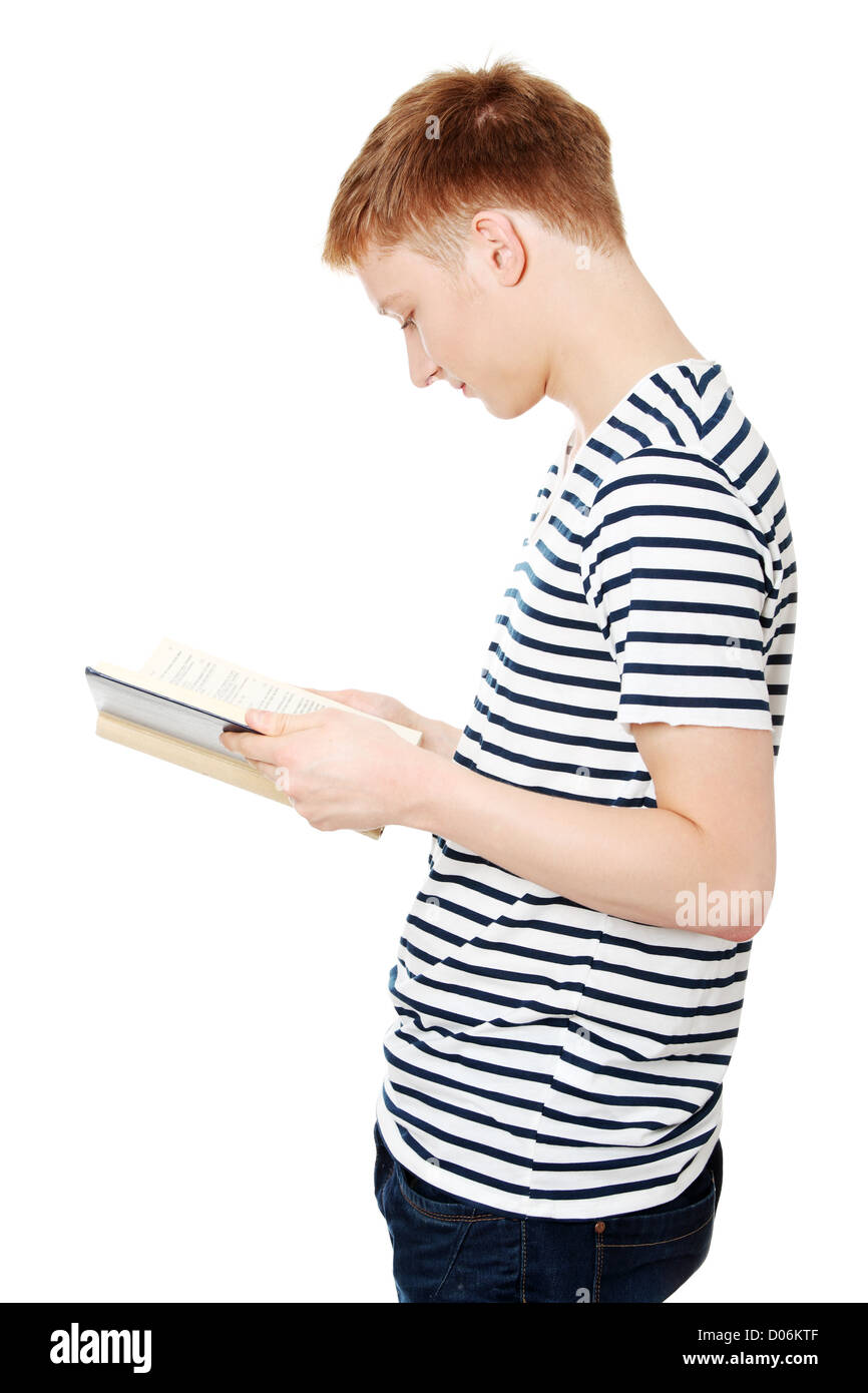 Young teen man is reading a book , isolated on white background Stock ...
