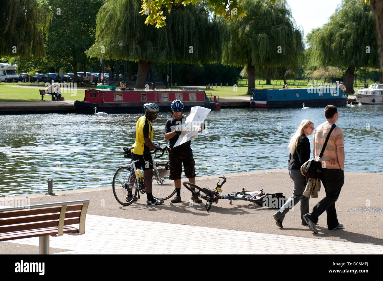 Cyclists studying map by River Avon, Stratford-upon-Avon, UK Stock Photo