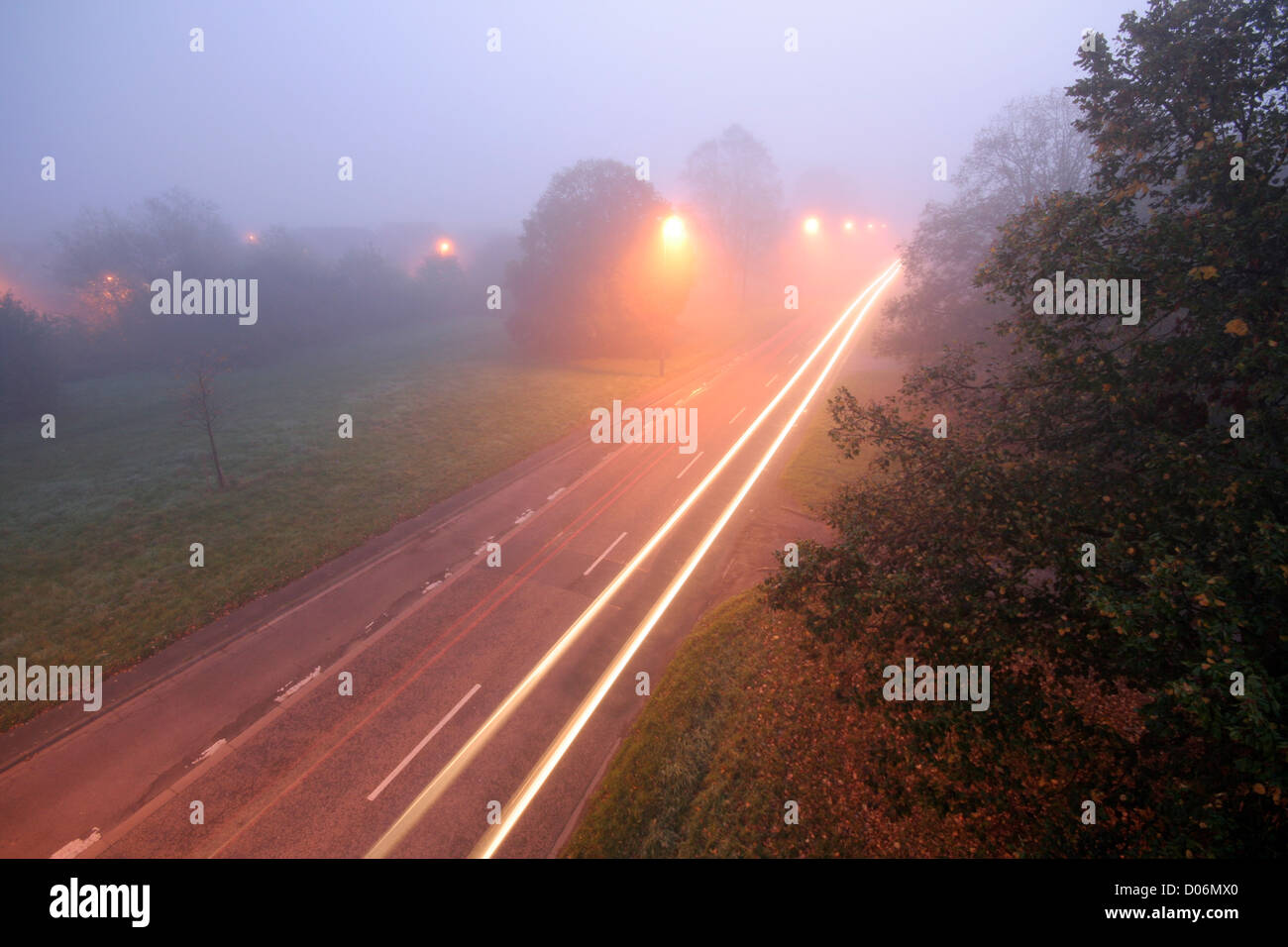 a foggy country road with headlight trails seen from above Stock Photo ...