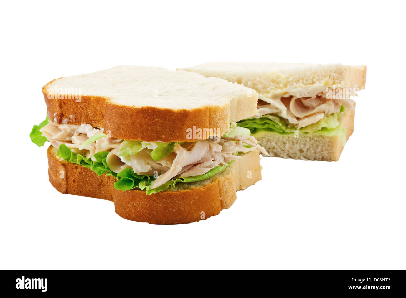 A turkey salad sandwich made with freshly sliced bread cut in half with focus on the filling Stock Photo