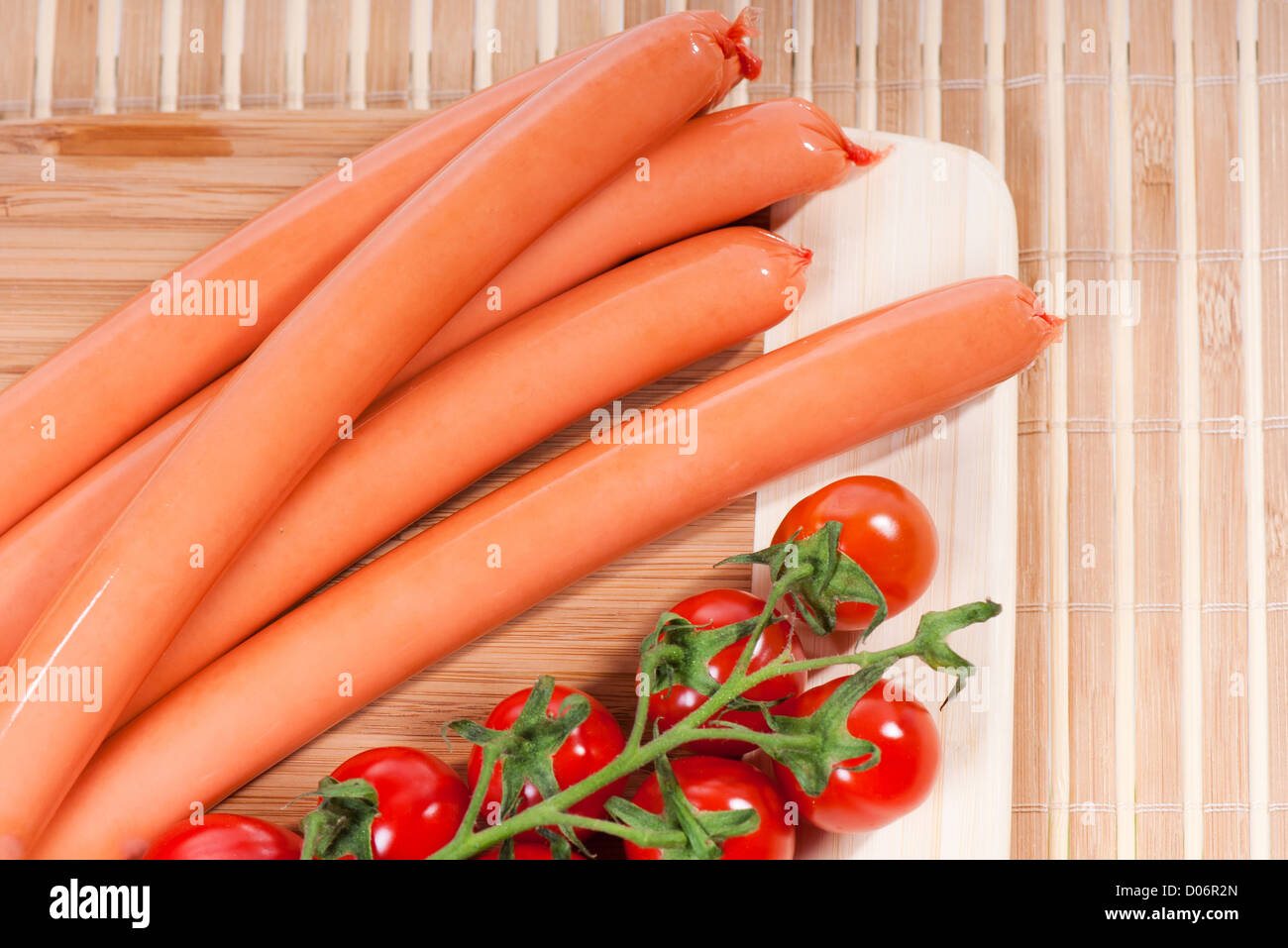 Smoked frankfurters bunch with red cherry tomato Stock Photo