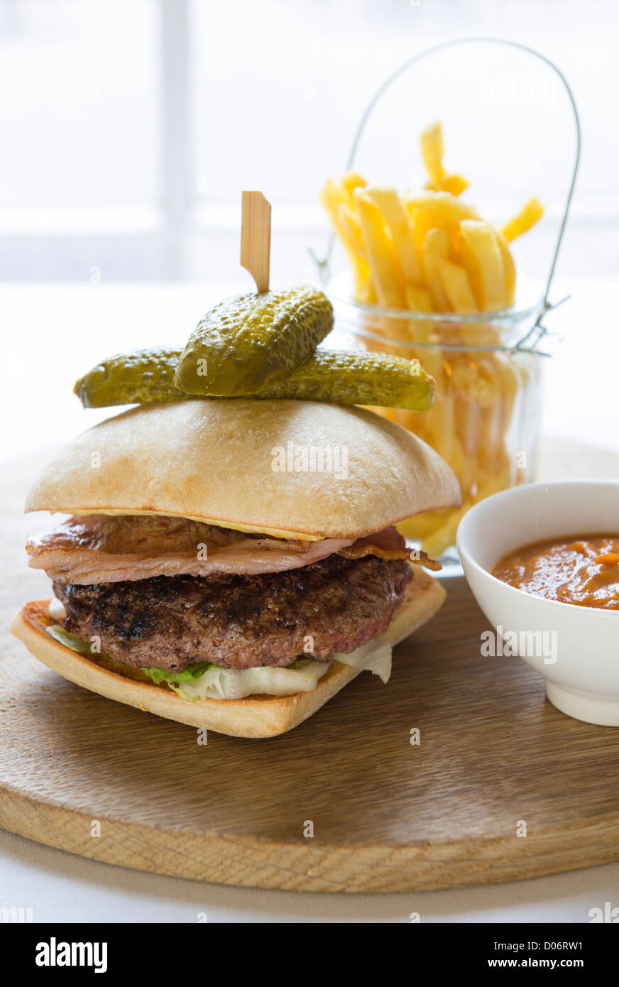 Beef burger and fries served in a restaurant. Stock Photo