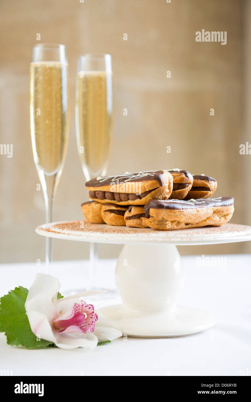 Chocolate eclairs and champagne Stock Photo