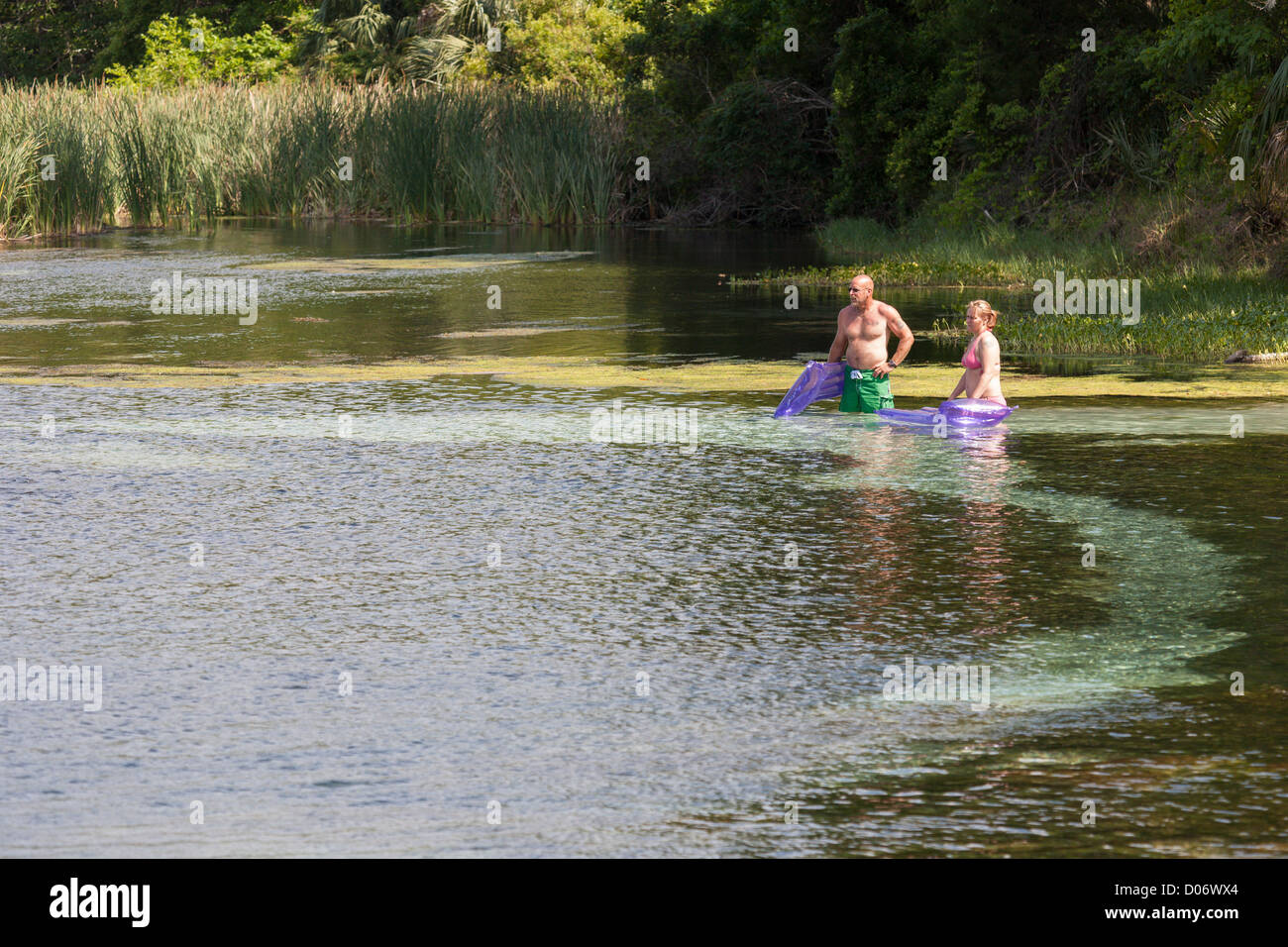 Middle aged man and woman preparing to float on rafts at Salt Springs Recreation Area in the Ocala National Forest, Florida Stock Photo