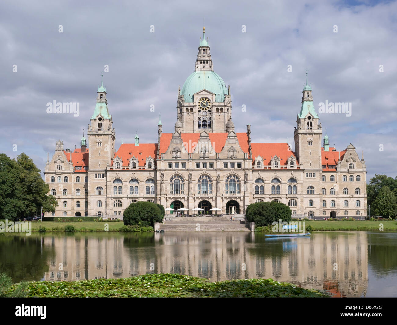 The Neues Rathaus (new city hall) in Hannover, Germany. It is set in a public park with trees and a large lake. Stock Photo