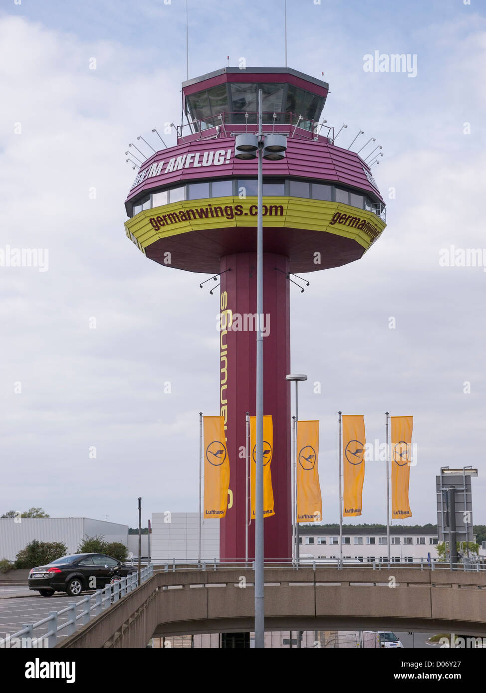 The air traffic control tower at Hannover airport, Germany. It is painted in the colours and logo of the Germanwings airline. Stock Photo