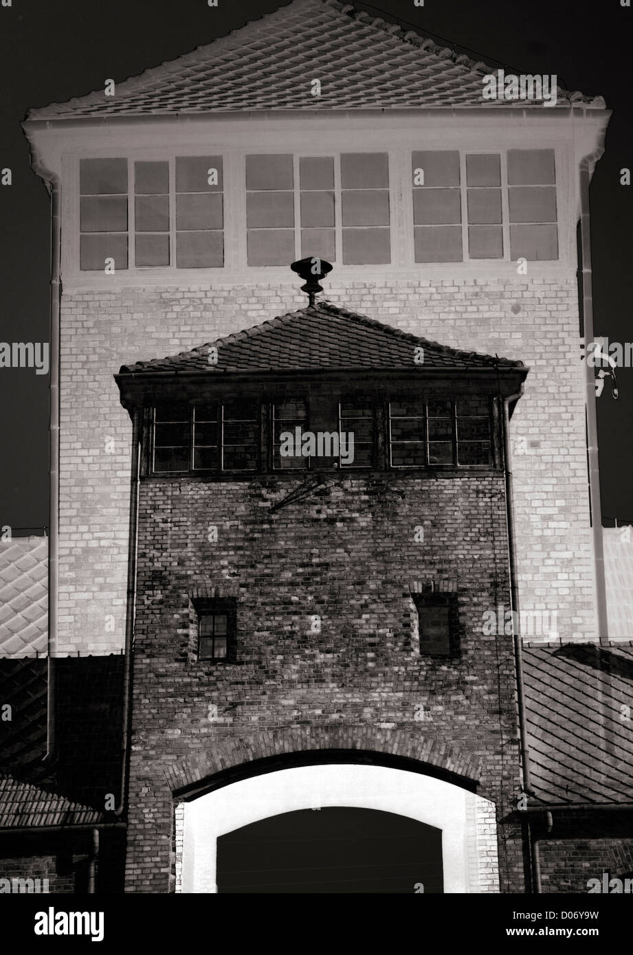 Auschwitz  Auschwitz-Birkenau Oswiecim Poland The Gate of Death presented as a composite montage as toned monochrome Stock Photo