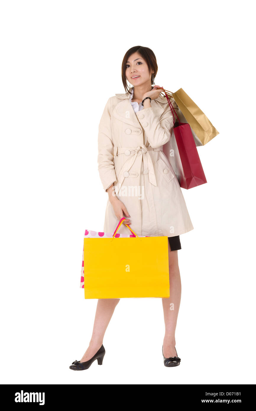 Happy smiling shopping woman holding bags and looking at you, full ...