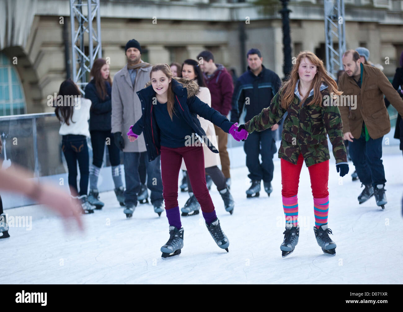 London Eye's annual ice rink, enabling people to skate underneath the 443ft tall structure at the capital's Southbank, London UK Stock Photo