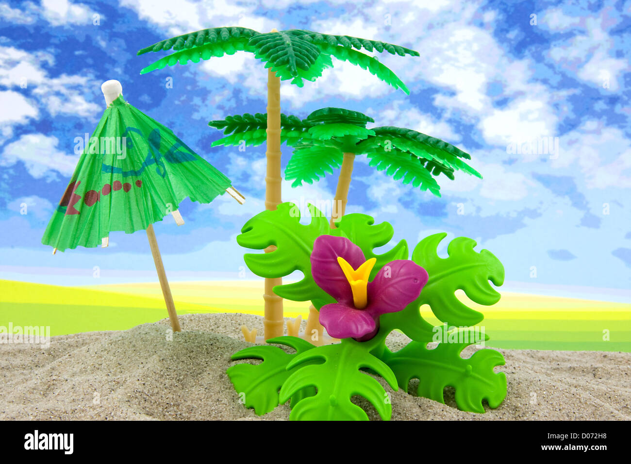plastic toy palm tree and umbrella at the beach Stock Photo Alamy