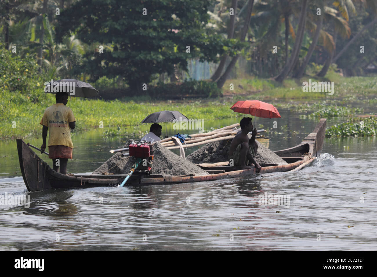 A Canoe carrying goods across the backwaters of kerala Stock Photo Alamy