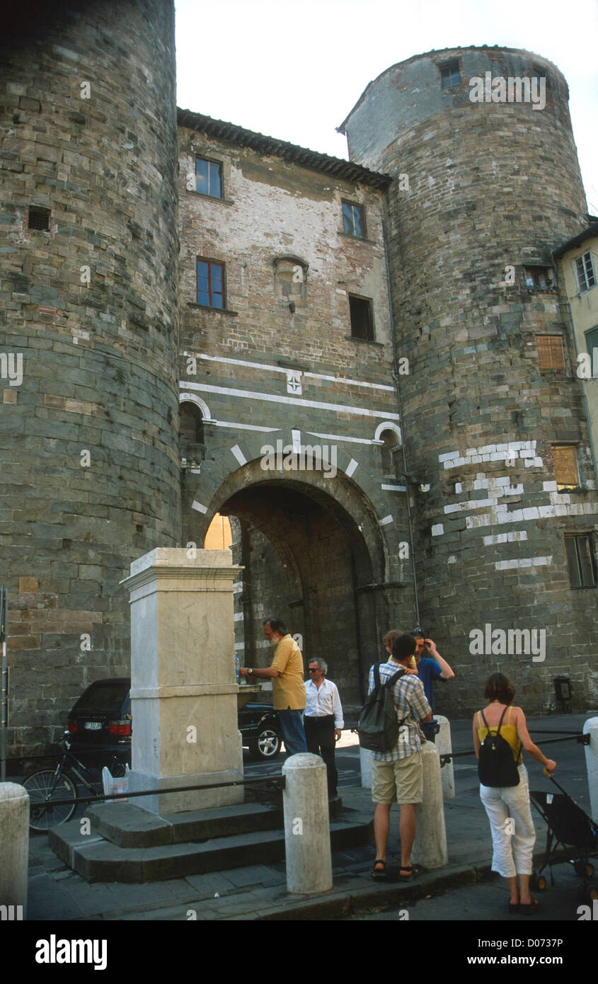 water fountain with people at Porta del Santi Lucca Tuscany Italy Stock Photo