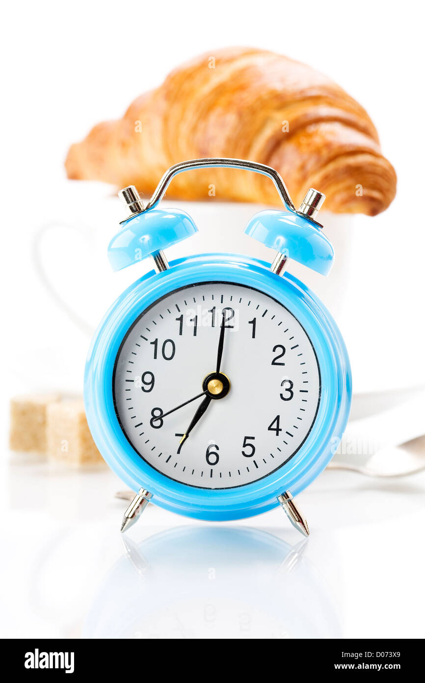 Alarm clock, coffee and  croissant on white Stock Photo