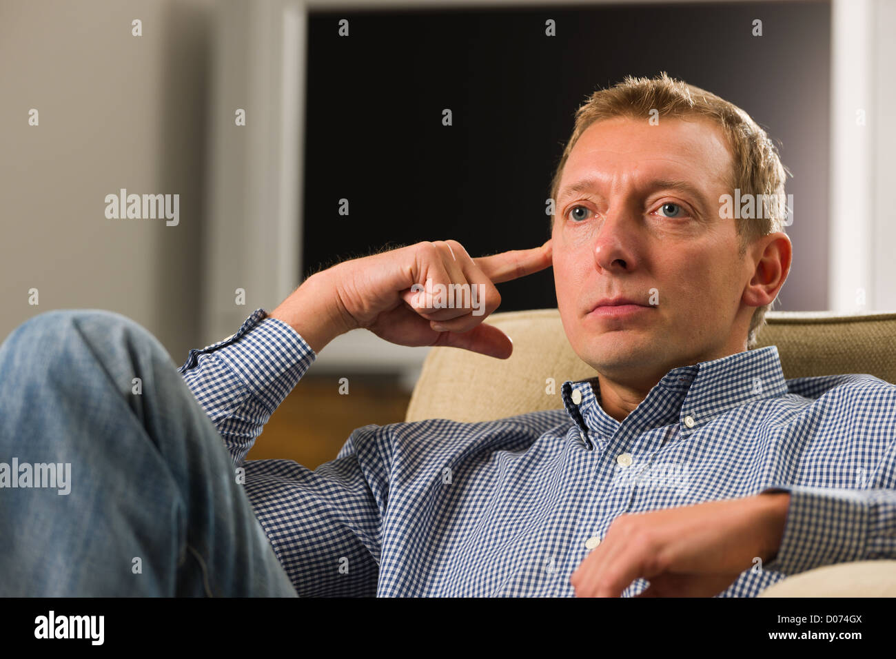 Man sitting on the armchair and thinking something Stock Photo Alamy