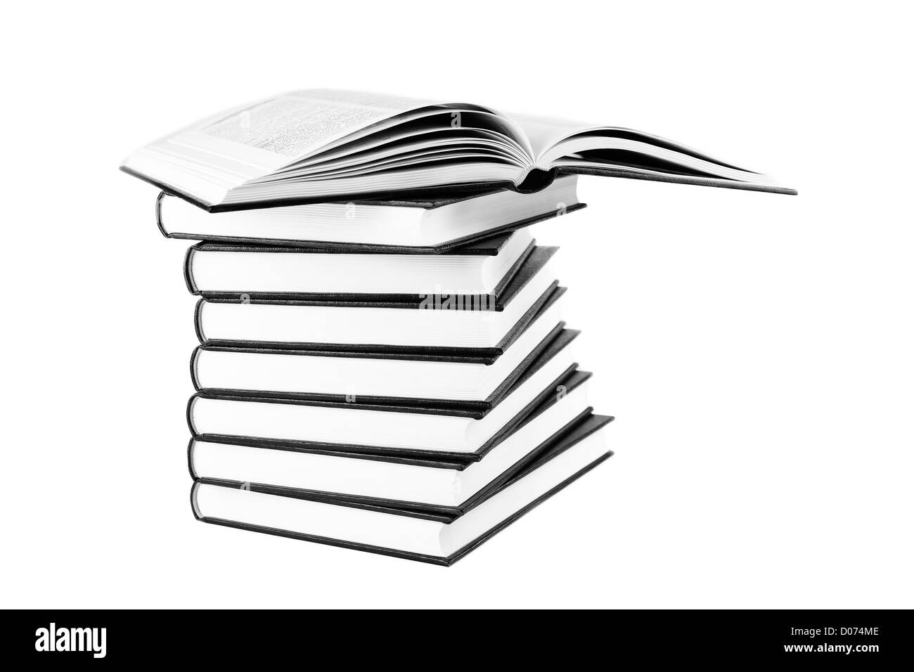 Many books in pile and white isolated background black and white photo. Stock Photo