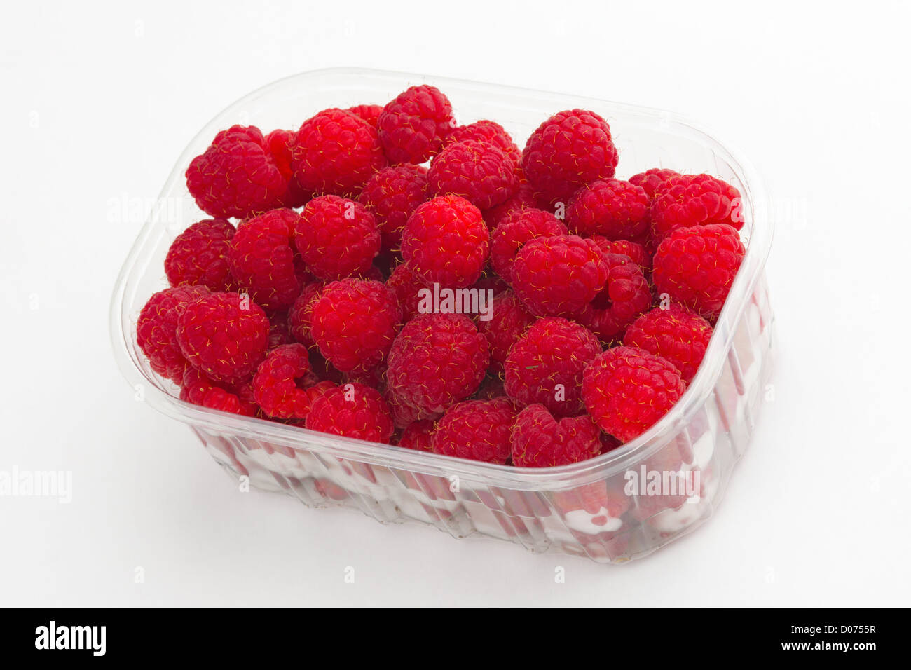 Raspberries in the plastic case, white background. Stock Photo