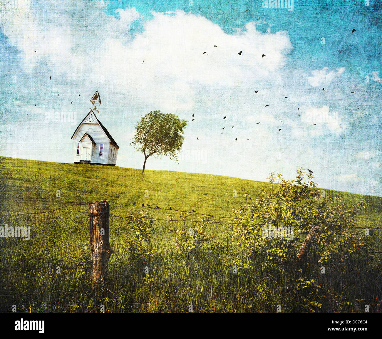 Old country school house on a hill against a blue sky Stock Photo