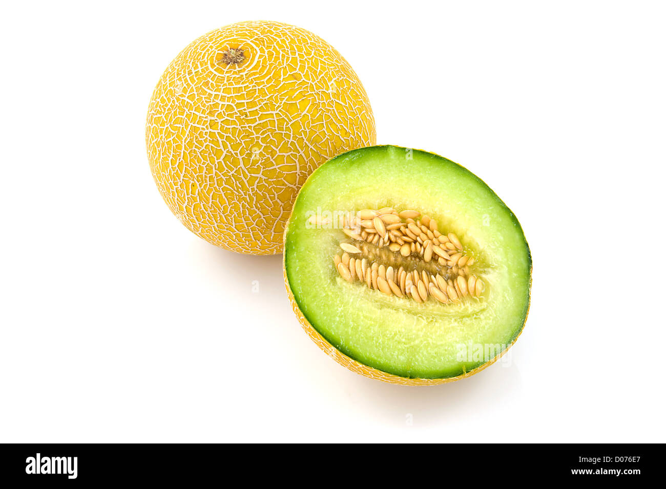 Whole and half fresh yellow melon over white background Stock Photo