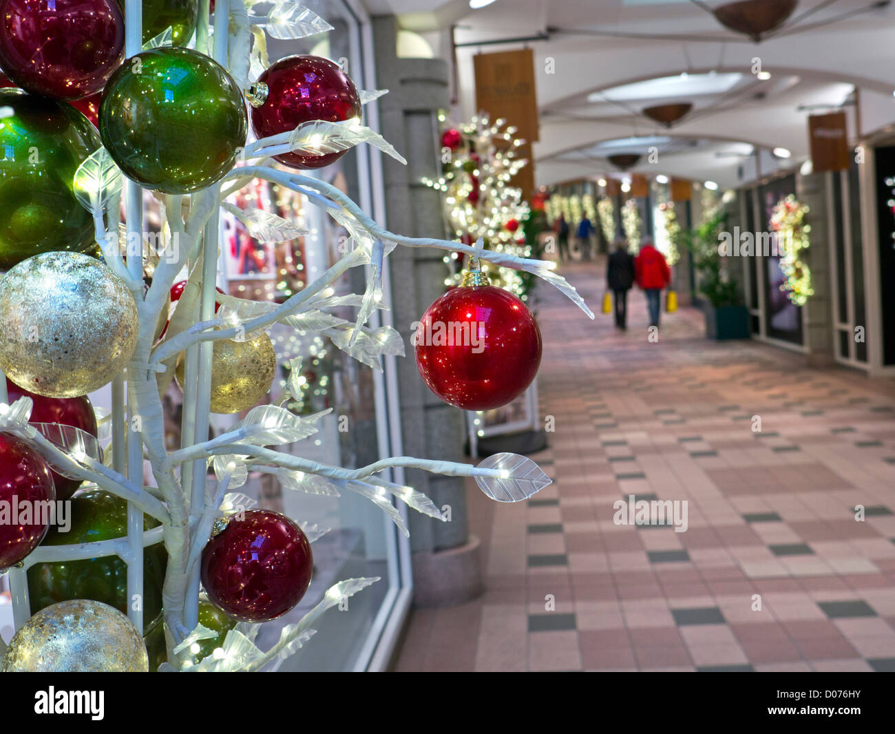 Traditional Christmas decorations in foreground with couple carrying