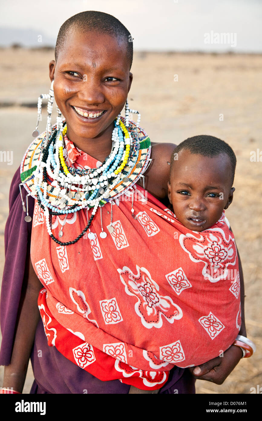 Smiling Maasai woman or Mother with babies at Tanzania;East Africa;Africa;Authentic Cultural Village in Olpopongi;Maasai Stock Photo