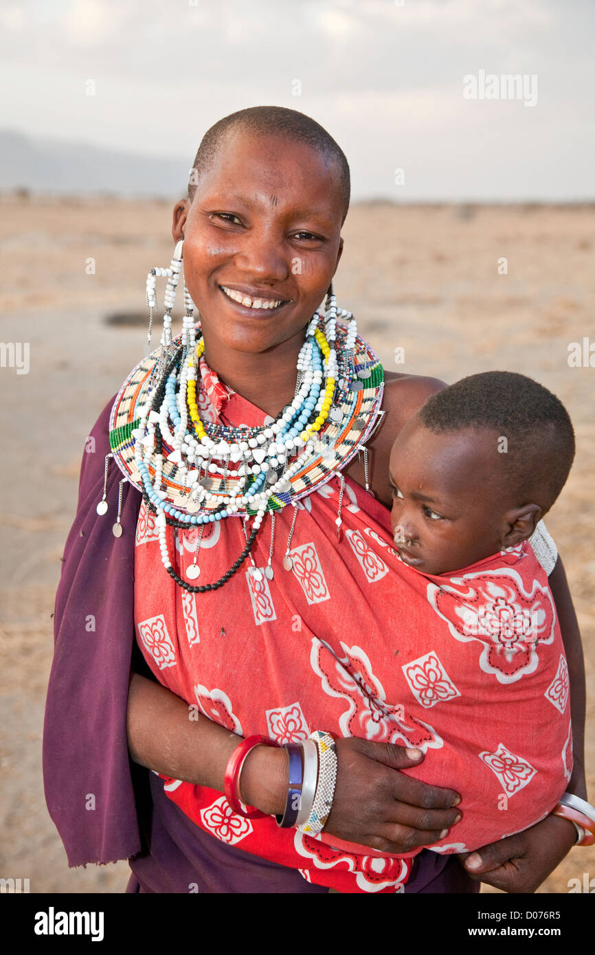 Happy smiling Maasai Mother with babies at Tanzania;East Africa;Africa;Authentic Cultural Village in Olpopongi;Maasai Stock Photo