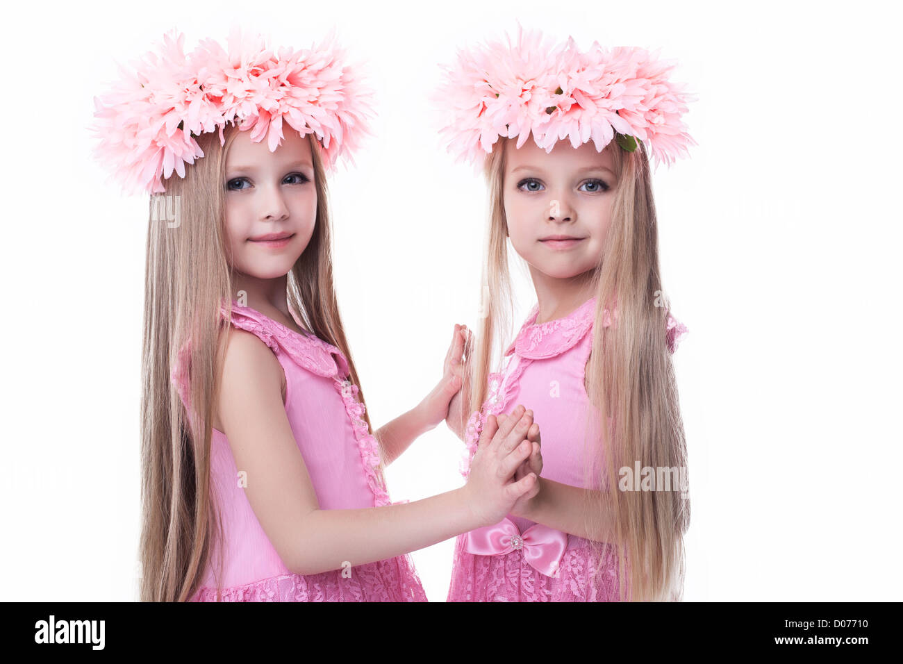 Two beautiful little girls in pink dresses. Isolated on white Stock ...