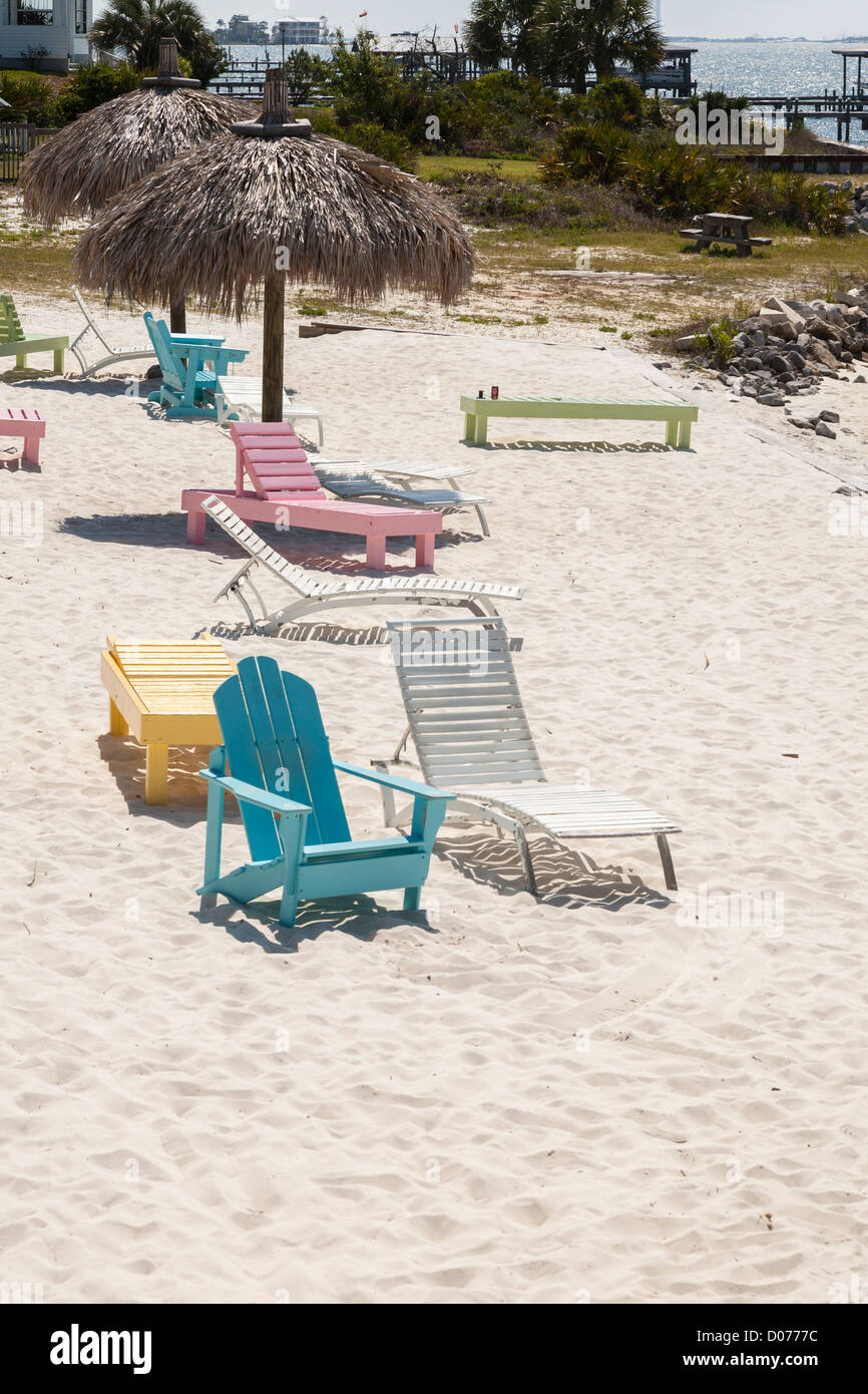 Wooden beach chairs under thatch umbrella on Santa Rosa Sound at
