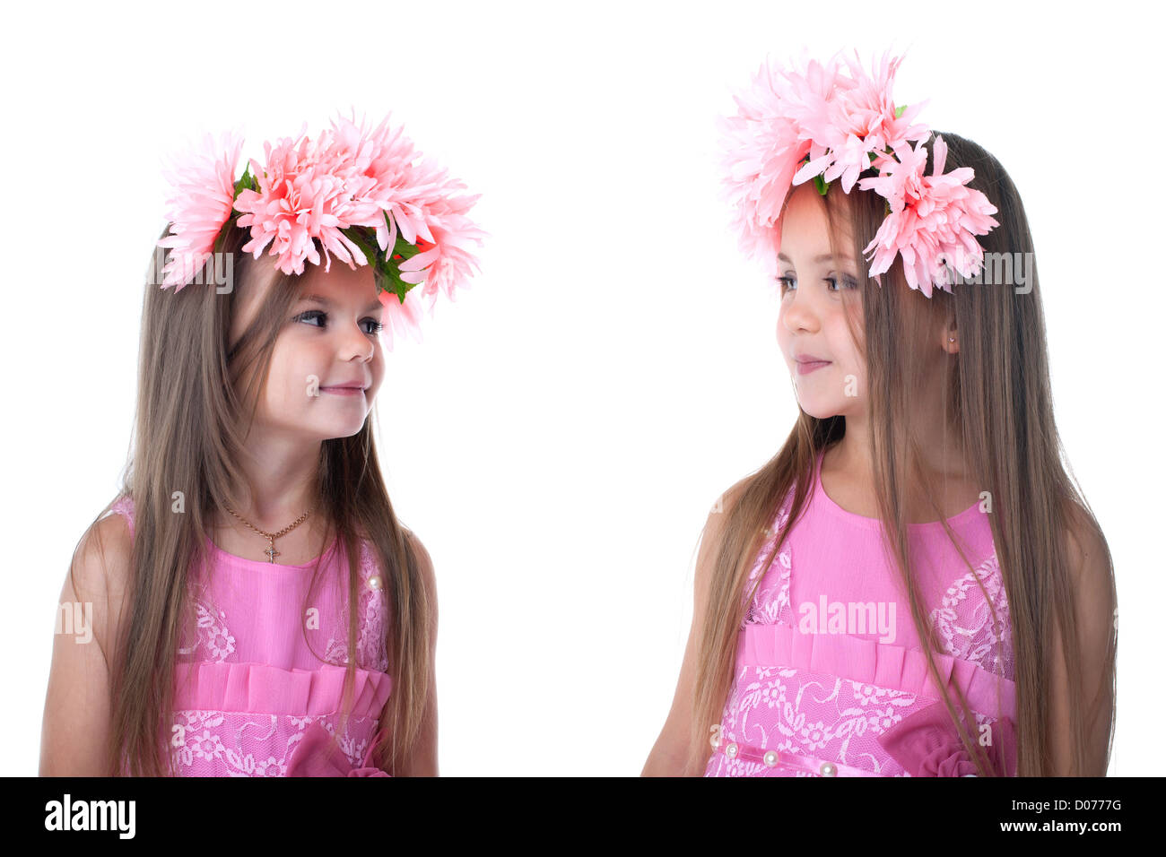 Two little girls in pink dresses. Isolated on white Stock Photo - Alamy