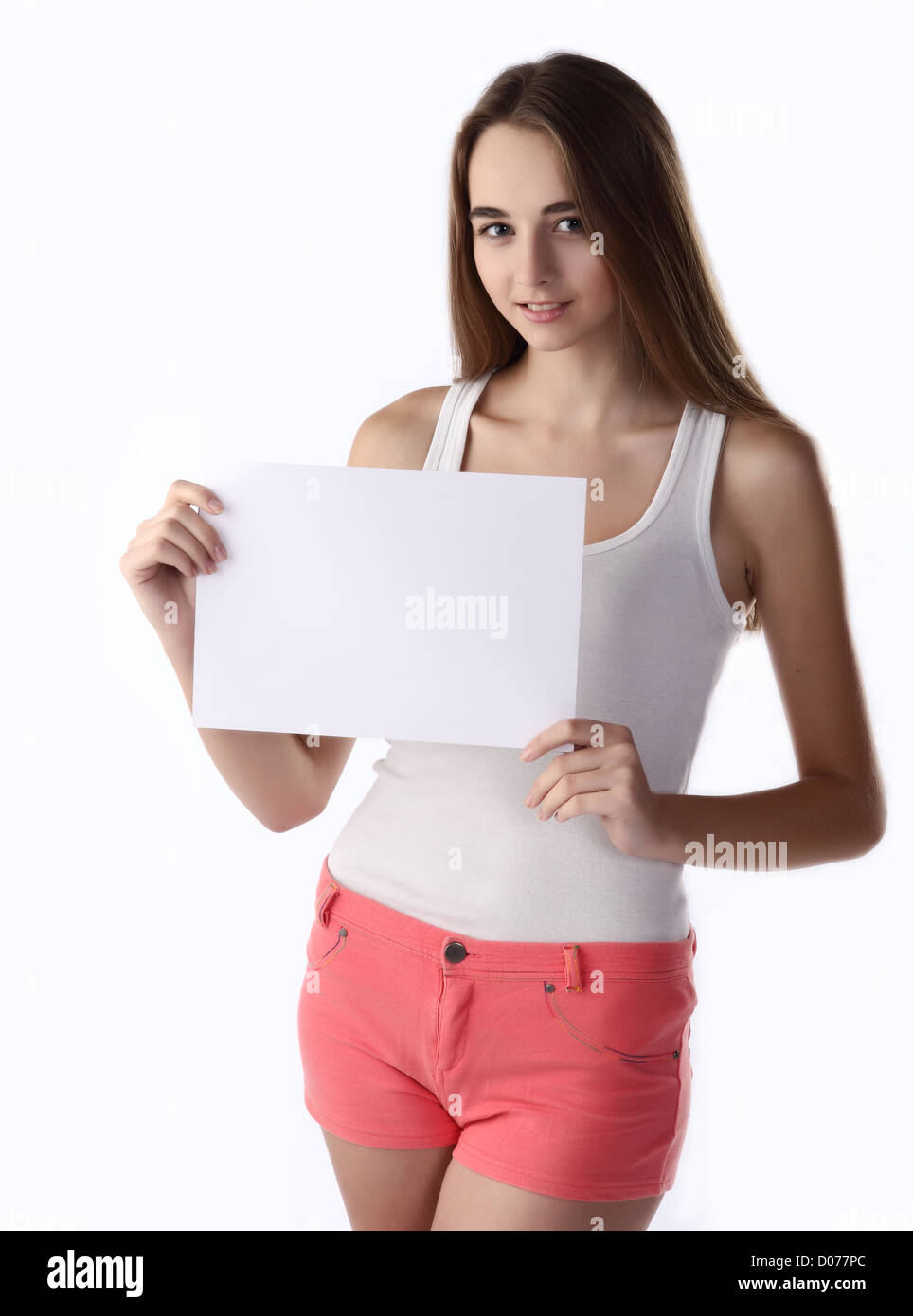 isolated on white: teenager girl smiling and holding paper blank on the white background Stock Photo
