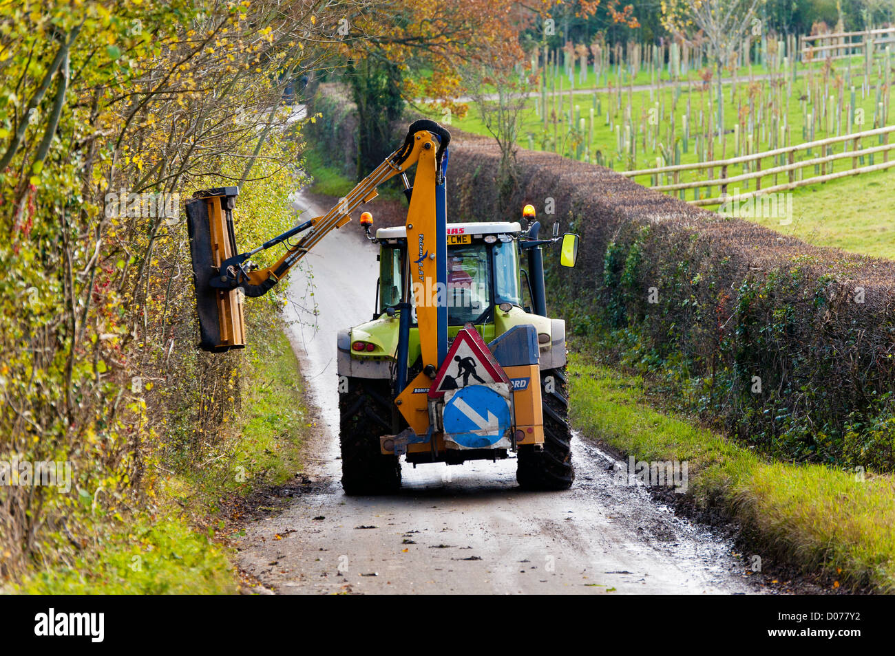 tractor at work cutting back trees Stock Photo