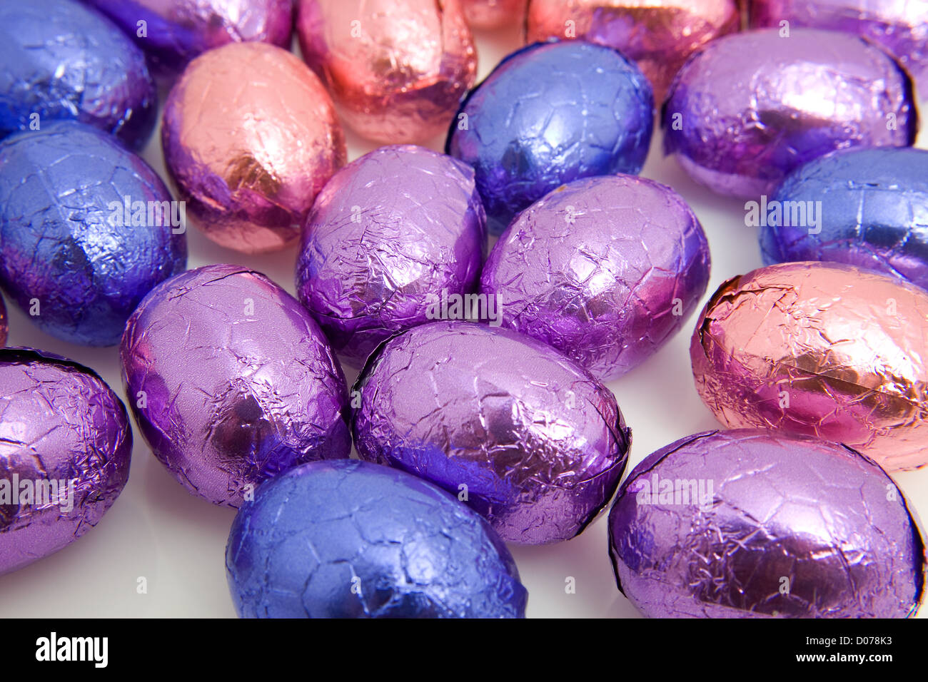 colorful chocolate easter eggs in closeup over white background Stock