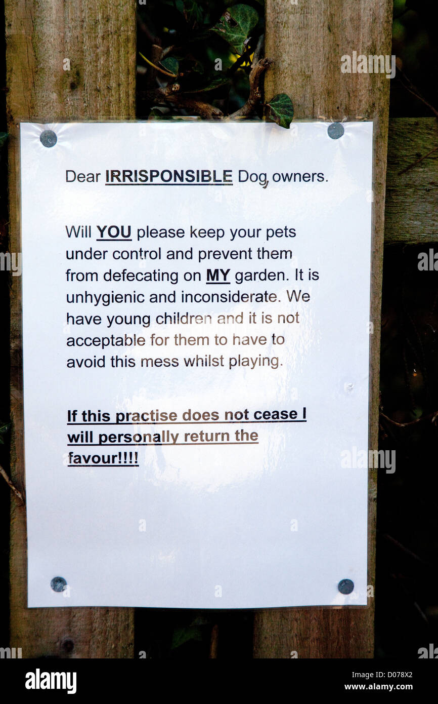 Funny notice sign about dog fouling on a private house, England UK Stock Photo