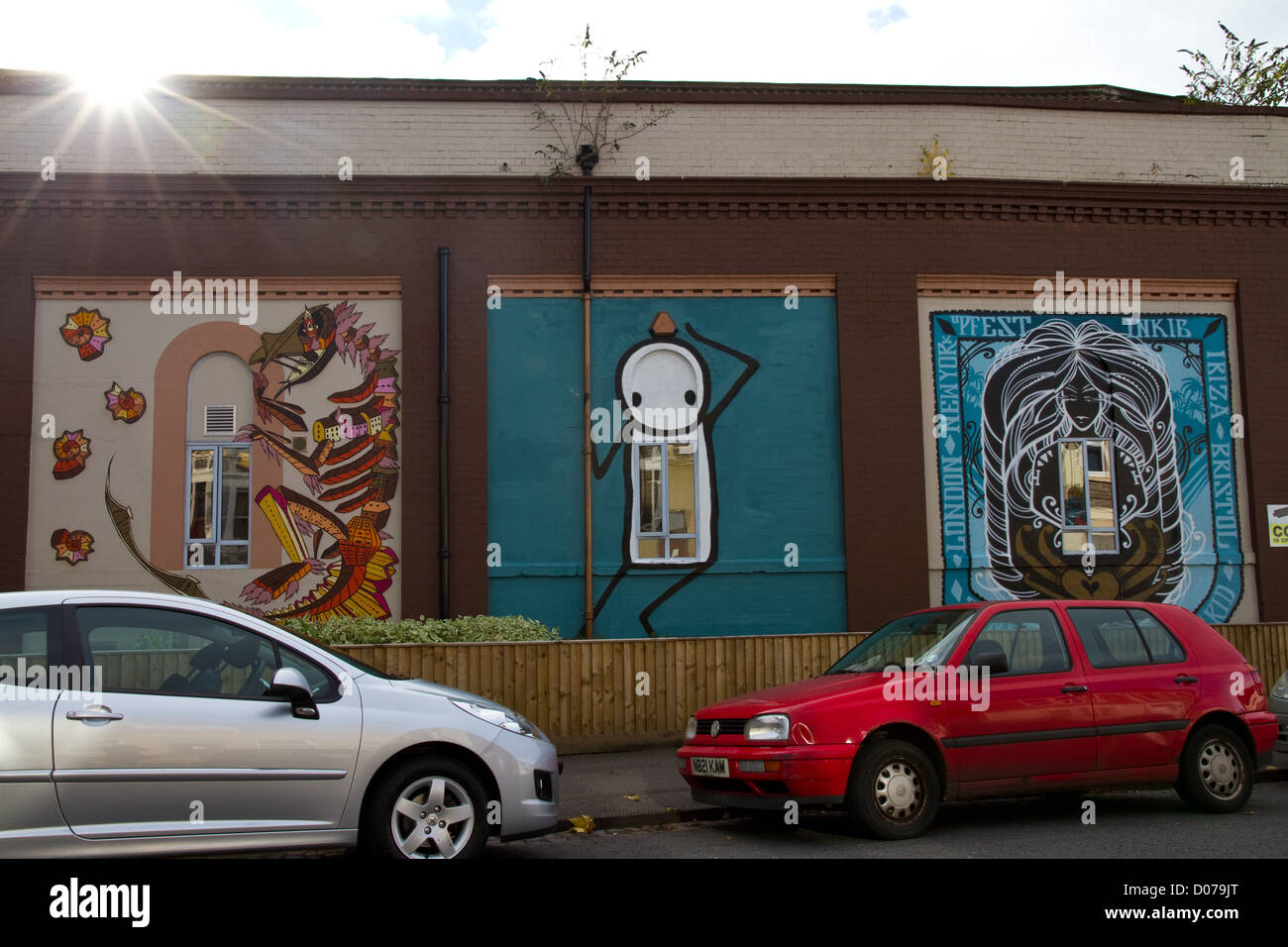 A triptych of three pieces of urban graffiti on the side of a building on North Street, Bedminster, Bristol Stock Photo